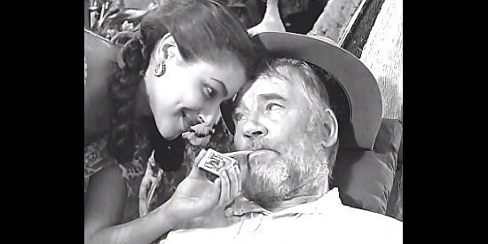 Walter Huston as Howard, being treated like a king in an Indian village after saving the life of a young boy in The Treasure of the Sierra Madre (1948)