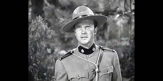William Lundigan as Jim Gardiner, the Mountie trying to track down his man in Northwest Rangers (1942)