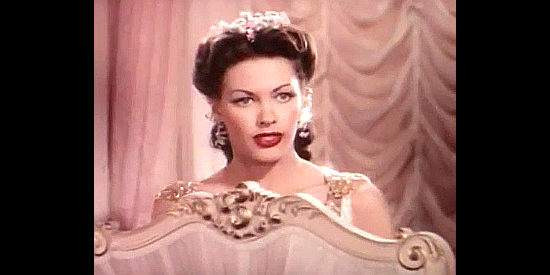 Yvonne De Carlo as Salome listens to war correspondent Jim Sneed's devious plan in Salome Where She Danced (1945)