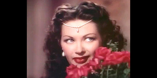 Yvonne De Carlo as Salome turns on the charm to charm secrets out of a court in Salome Where She Danced (1945)