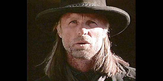 Ed Harris as Jim Lassiter, a gunmen in search of the men responsible for his sister's suicide in Riders of the Purple Sage (1996)