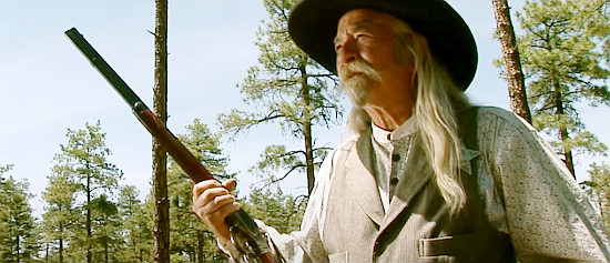 John Boyer as Teach Conley, the aging lawman who joins the hunt for a killer in Bannock (2014)