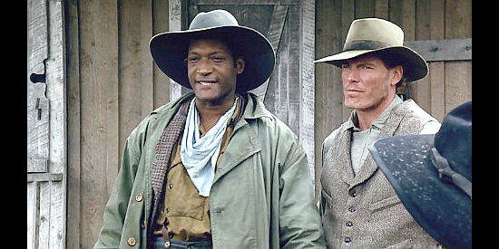 Tony Todd as Britt Johnson and Christopher Reeve as Alan Johnson, proposing a plan to bring back the captives in Black Fox (1995)