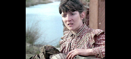 Glenne Headly as Elmira Boot Johnson, realizing a stranger will be joining her journey on Lonesome Dove (1989)