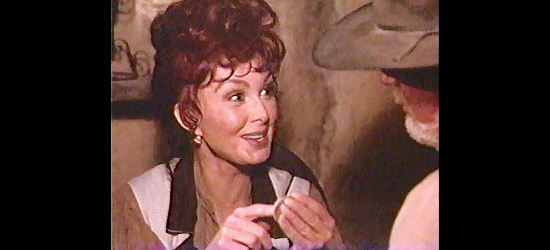 Naomi Judd as Flora Mae Pepper, thrilled to get another visit from Leech in Rio Diablo (1993)