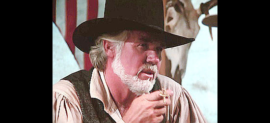 Kenny Rogers as Brady Hawkes, showing off a piece of evidence in The Gambler -- The Legend Continues (1987)