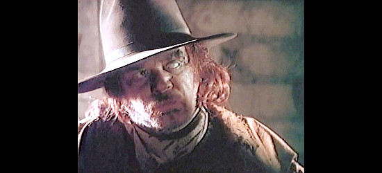 Kevin Conway as Mox Mox, the killer who likes to burn his victims alive in Streets of Laredo (1995)