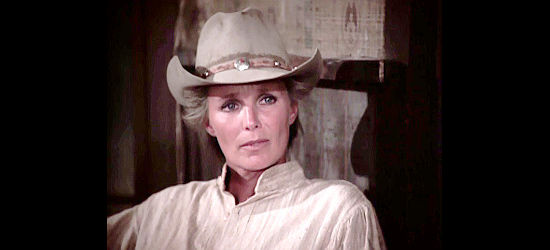 Linda Evans as Kate Muldoon, the female bounty hunter, learning more about Brady Hawkes in The Gambler -- The Adventure Continues (1983)