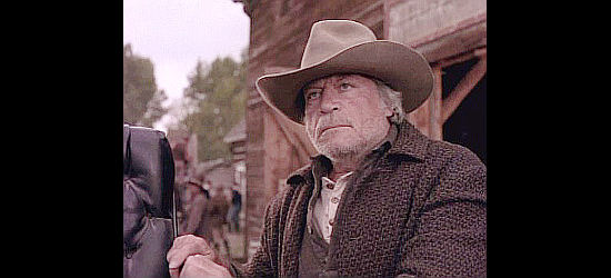 Oliver Reed as Gregor Donnigan, owner of the largest ranch in Montana and husband of a lovely young beauty named Ferris in Return to Lonesome Dove (1993)