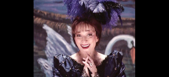 Dixie Carter as Lillie Langtry, flirting with Brady Hawkes from the stage in The Gamber V, Playing for Keeps (1994)
