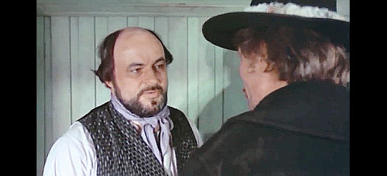 Heinrich Schweiger as saloon owner Sam Jenkins, providing information to the Tornado Kid in The Cry of the Black Wolves (1972)