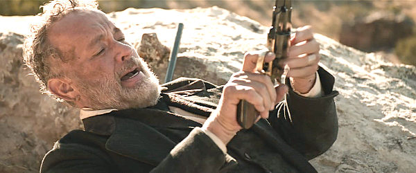 Tom Hanks as Capt. Jefferson Kyle Kidd desperately reloading his pistol as Almay and his men draw closer in News of the World (2020)