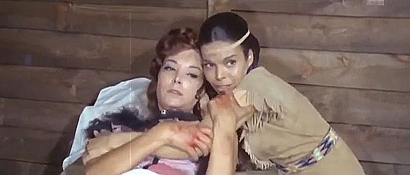 Kiola (does anyone know who plays this part) comforts Brenda (Elisa Montes) once she's taken to Fort Sharp for treatment of her wounds in Mutiny at Fort Sharp (1966)