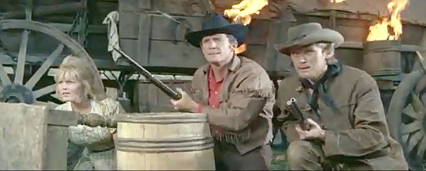 Olga Schoverova as Mary Brendel, Brad Harris as Phil Stone and Horst Frank as Dan McCormick with the wagon train under attack in Massacre at Marble City (1964)