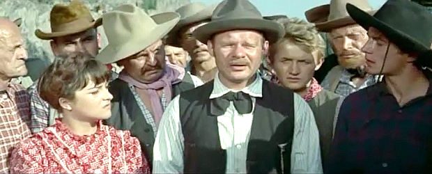 Ralf Wolter as Tim Fletcher, sharing an Indian warning with the settlers in Massacre at Marble City (1964)