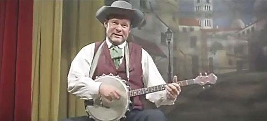 Ralf Wolter as minstrel Billy Monroe, performing the Ballad of Johnny Ringo in Who Killed Johnny R? (1966)