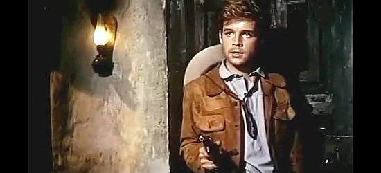 Thomas Fritsch as Carlos, the youngest member of the Ortiz gang, standing up to his boss in Last Ride to Santa Cruz (1964)