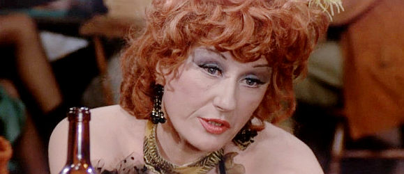 Danika La Loggia as Irs, the madam and friend to the three buddies in Man of the East (1972)
