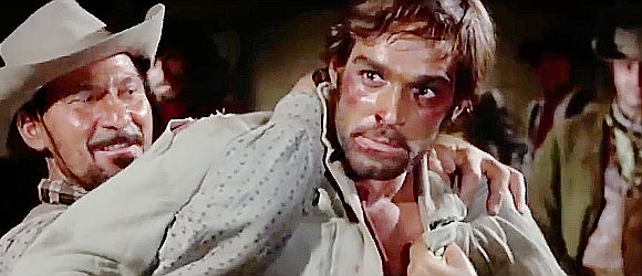Fabio Testi as Roy Greenfield, falling into the hands of Redfield's henchmen in Dead Men Ride (1971)