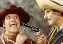 Franco Franchi as Franco Catarena under the gun of Sgt. Ciccio Stevens (Ciccio Ingrassia) in Two R-R-Ringos from Texas (1967)