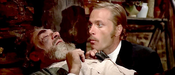 Franco Nero as Prince Orlowsky, learning about the hidden gold from a dying man in Don't Turn the Other Cheek (1971)