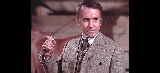 Ian Bannen as Sir Harry Norfolk reacts after Carbo shoots a whiskey bottle from his hand in Bite the Bullet (1975)