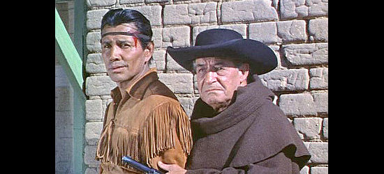 Jay Silverheels as Tonto being helped to the doctor's office by Padre Esteban (Ralph Moody) in The Lone Ranger and the Lost City of Gold (1958)