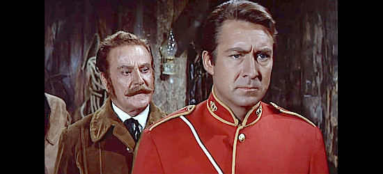 Mirko Ellis as Capt. Robert Doyle, being prodded to execute three suspected rebels by James Sullivan (Santiago Rivero) in Canadian Wilderness (1965)