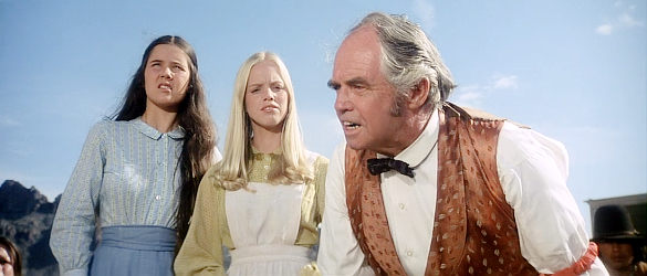 A townsman with the two young girls infatuated with members of Nightingale's posse in Posse (1975)