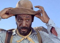 Bill Cosby as Caleb Revers, ready to set out to retrieve a stolen horse in Man and Boy (1971)