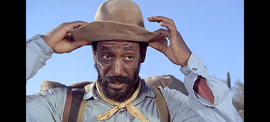 Bill Cosby as Caleb Revers, ready to set out to retrieve a stolen horse in Man and Boy (1971)