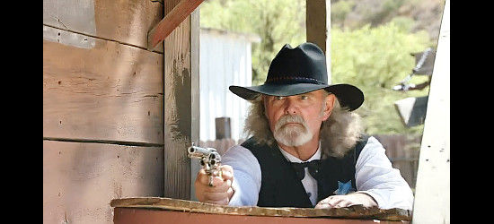 Bill Womack as the sheriff, unenthused about Tate Butler's presence in his town and attraction to his daughter in A Guide to Gunfighters of the Wild West (2021)