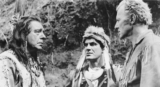 Bruce Bennett as Daniel Boone (right) meets with Chief Blackfish (Lon Chaney Jr.) and trouble maker Simon Girty (Kem Dibbs) in Daniel Boone Trail Blazer (1956)
