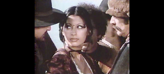Geo Anne Sosa as Chorika, surrounded by upset gamblers who know they've been cheated in The Master Gunfighter (1975)