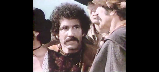 Hector Elias as Juan, Chorika's companion, sensing trouble in The Master Gunfighter (1975)