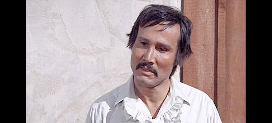 Henry Silva as Caine, a rancher sympathetic to Caleb Revers' plight in Man and Boy (1971)