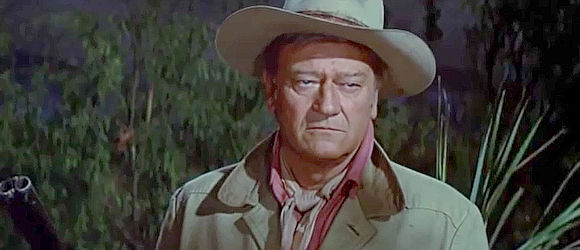 John Wayne as gruff, shotgun-toting Big Jake, listening to John Fain's demands in Big Jake (1971)