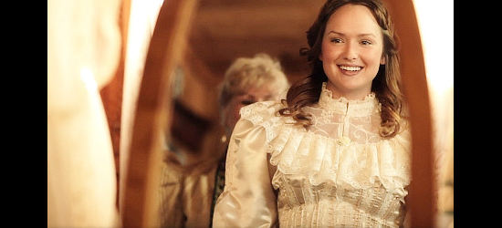 Kaylee DeFer as Mattie Springer, admiring herself in a wedding dress she tries on in Renegade (2011)