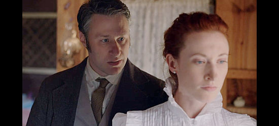 Robert Anthony Peters as Jonathan, trying to convince wife Mabel (Megan Therese Rippey) to stay away from the hanging in She Was the Deputy's Wife (2021)