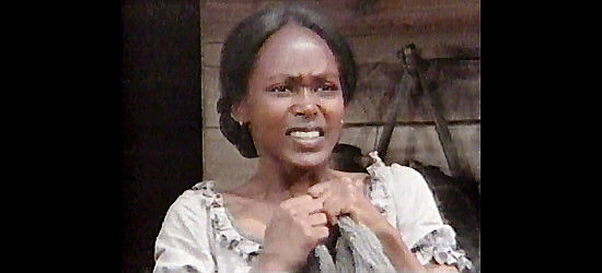 Brenda Sykes as Naomi, watching Quincy feel the sting of the whip in Skin Game (1971)