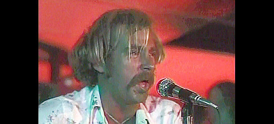Jimmy Buffett performing during a barroom scene in Rancho Deluxe (1975)