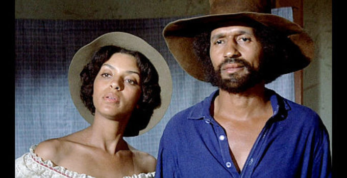 Vonetta McGee as Thomasine and Max Julien as Bushrod posing for a photo in Thomasine and Bushrod (1974)