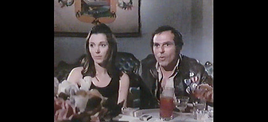 Donna Baccala as Miss Anderson and Don Gordon as Neville Robey, discussing worehouse floor shows in The Last Movie (1971)