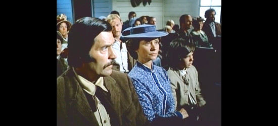 Diane Baker as Jenny Baker, in church with her husband Dan and son Billy in Baker's Hawk (1976)