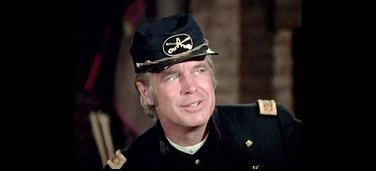 George Peppard as Maj. John David Harkness, in charge of an undermanned fort with Indian trouble brewing in The Bravos (1972)