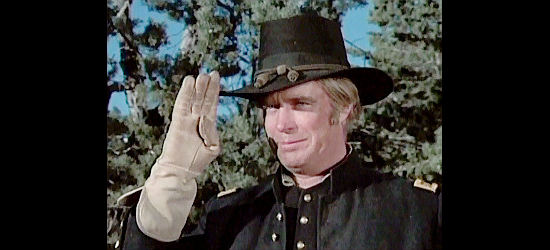 George Peppard as Maj. John David Harkness, saluting that captain who helps save he and his son in The Bravos (1972)