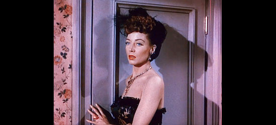 Marie Windsor as Iron Mae McLeod, considering her options for the Paradise Saloon in Outlaw Women (1952)