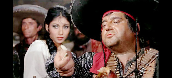 Nestor Garay as Juarez, a bandit leader taking pleasure in torturing his captives as Juana (Dalia Besciani) looks on in Execution (1968)