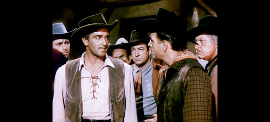 Richard Avonde as Frank Slater, explaining an upcoming holdup to his gang in Outlaw Women (1952)