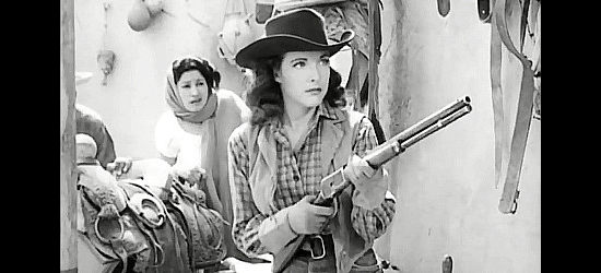 Cathy Down as Jean 'Dusty' Stewart, thinking she's been shortchanged in a purchase of saddles in Panhandle (1948)